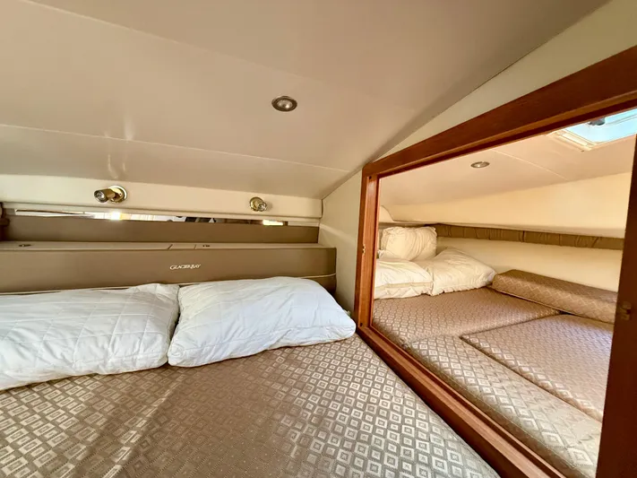  Yacht Photos Pics 2007 Glacier Bay 3480 Ocean Runner cabin interior with cozy bedding and wooden accents.