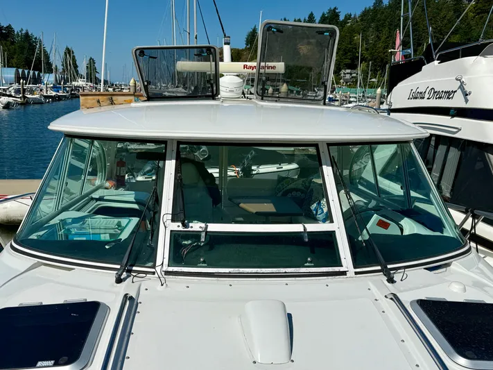  Yacht Photos Pics 2007 Glacier Bay 3480 Ocean Runner boat docked at a marina, surrounded by other vessels.