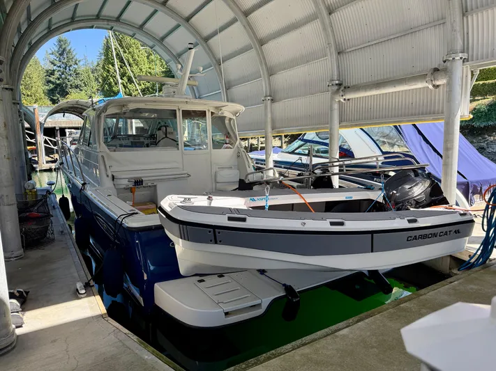  Yacht Photos Pics 2007 Glacier Bay 3480 Ocean Runner docked under a covered marina.