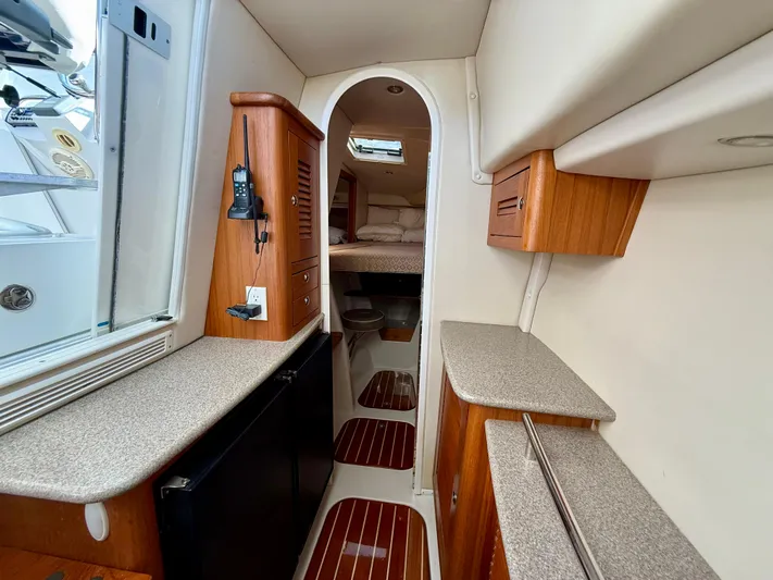  Yacht Photos Pics Interior of 2007 Glacier Bay 3480 Ocean Runner, featuring wood cabinetry and compact design.