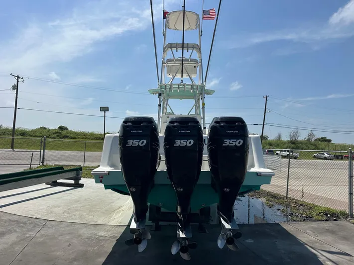  Yacht Photos Pics 2013 SeaVee 390B boat with triple 350 horsepower engines, docked under a clear sky.