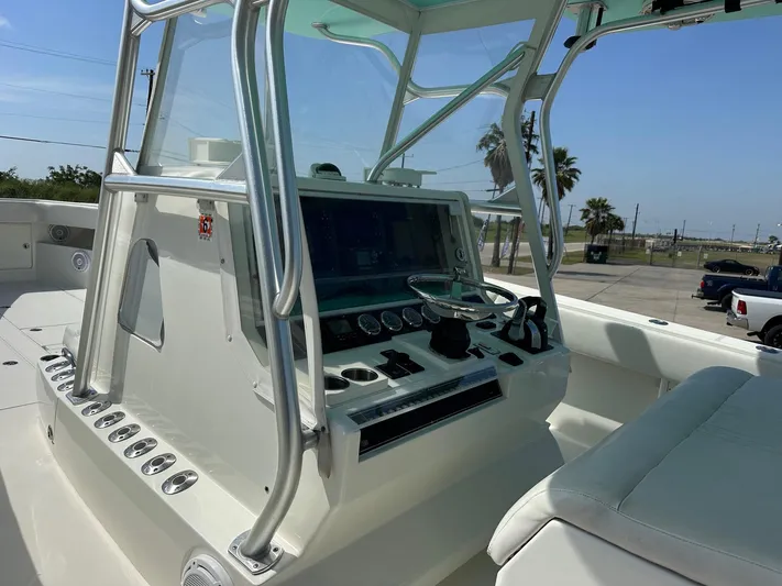  Yacht Photos Pics 2013 SeaVee 390B boat console with steering wheel and navigation controls.