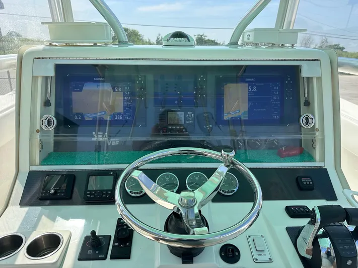  Yacht Photos Pics 2013 SeaVee 390B boat dashboard with steering wheel and navigation displays.