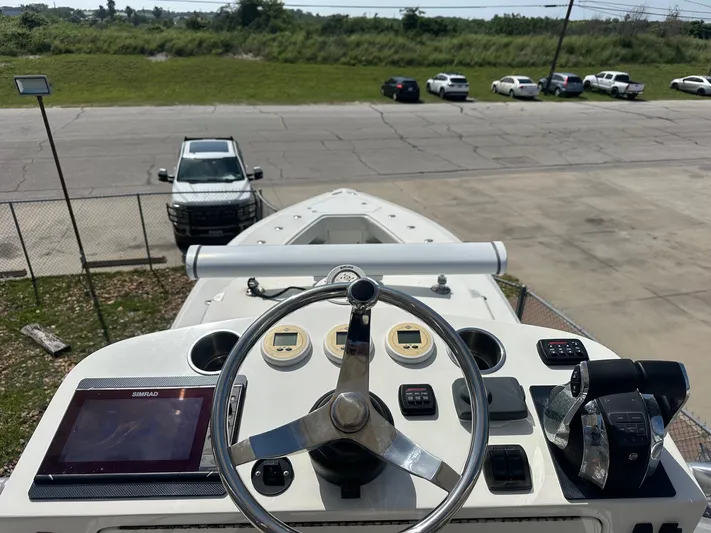  Yacht Photos Pics 2013 SeaVee 390B boat helm with steering wheel and navigation controls.