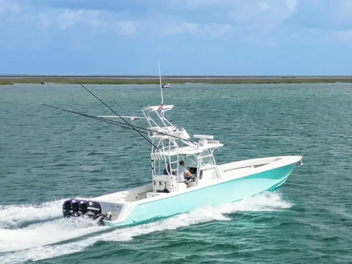  Yacht Photos Pics 2013 SeaVee 390B boat cruising on open water with fishing rods.