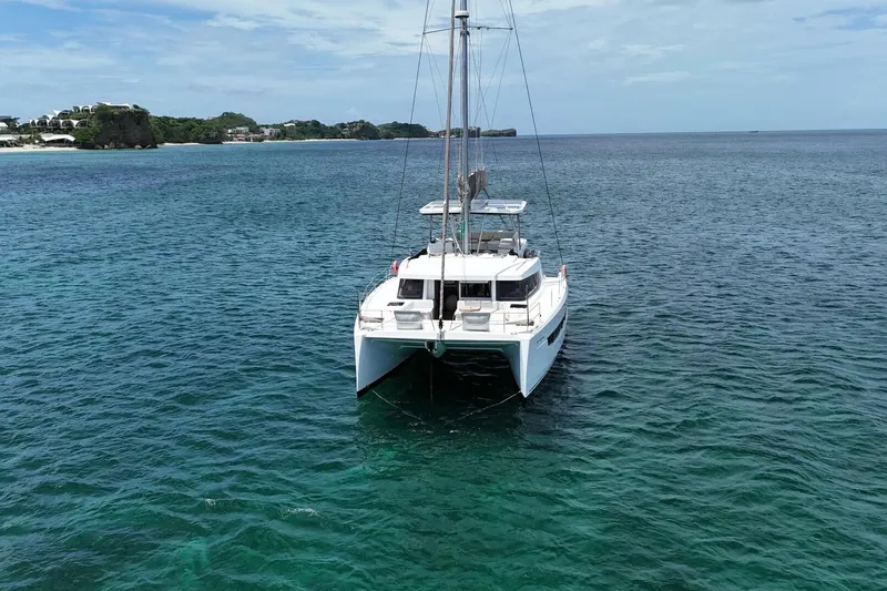 My Marina Yacht Photos Pics 2020 Bali 4.8 catamaran sailing on clear blue ocean near a scenic coastline.