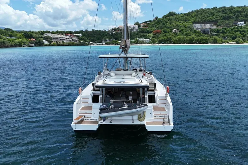 My Marina Yacht Photos Pics 2020 Bali 4.8 catamaran anchored in clear blue waters near lush green coastline.