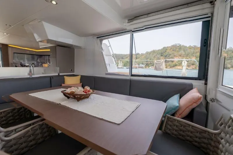 My Marina Yacht Photos Pics Luxurious interior of 2020 Bali 4.8 yacht with dining area and scenic window view.