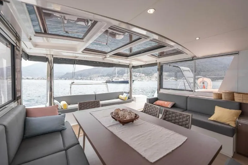 My Marina Yacht Photos Pics Luxurious interior of 2020 Bali 4.8 catamaran with panoramic windows and comfortable seating.