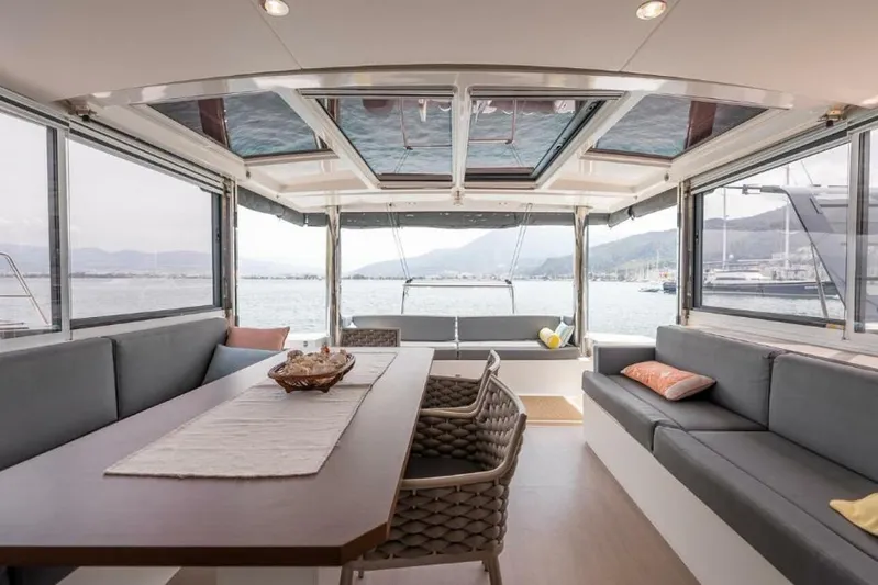 My Marina Yacht Photos Pics Luxurious interior of 2020 Bali 4.8 yacht with panoramic windows and elegant seating.