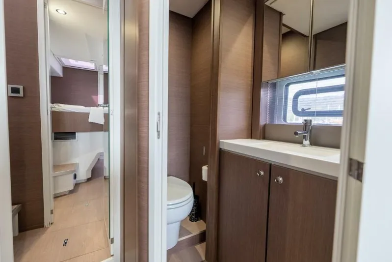 My Marina Yacht Photos Pics Modern bathroom interior on 2020 Bali 4.8 yacht, featuring sleek wood cabinetry and compact design.