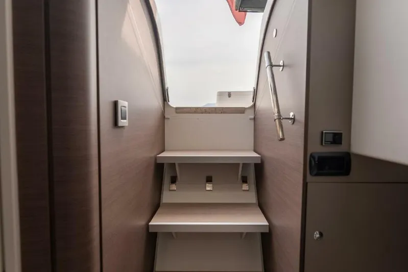 My Marina Yacht Photos Pics Interior stairs of a 2020 Bali 4.8 yacht, featuring sleek wooden design.