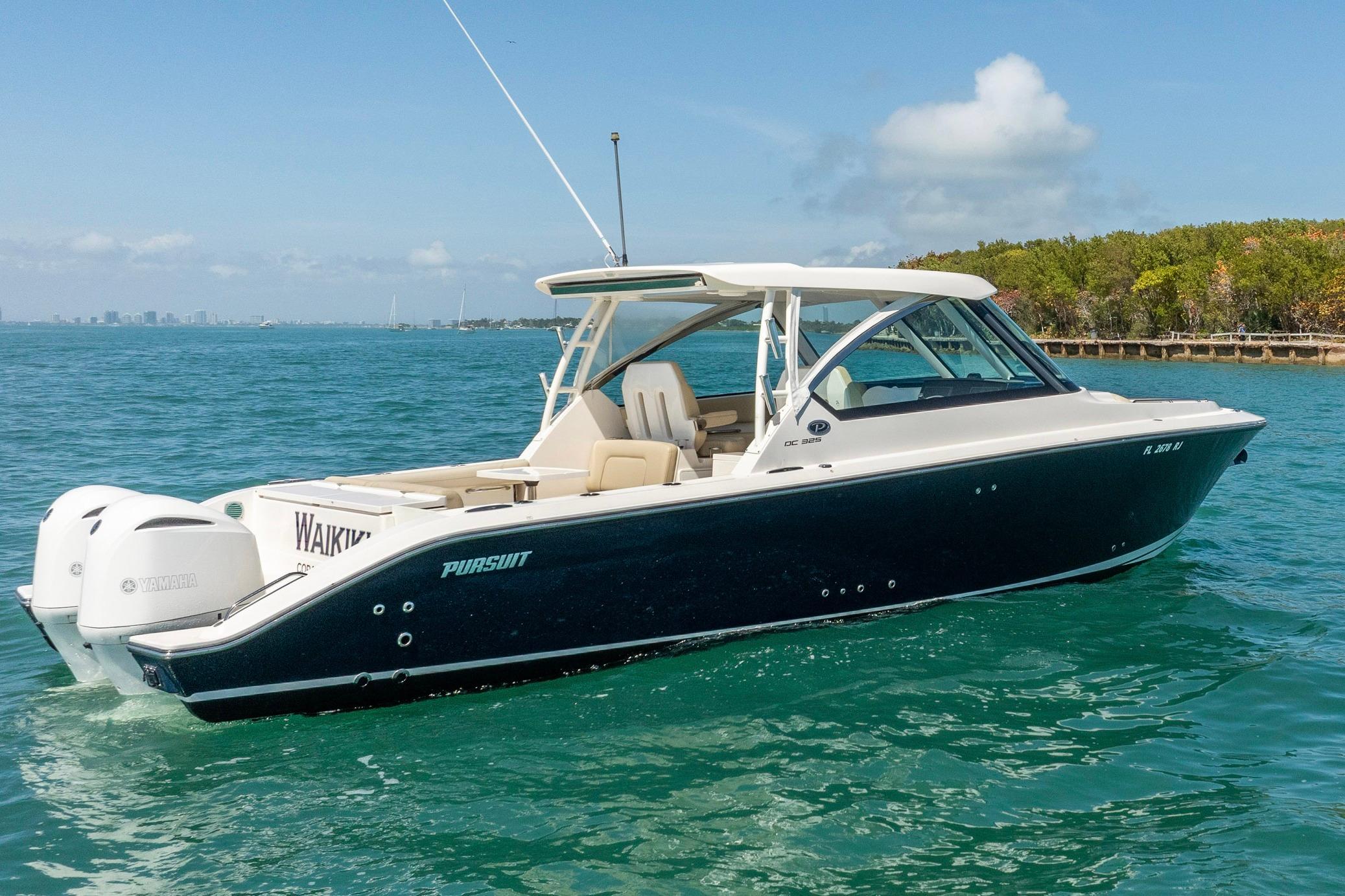 2017 Pursuit DC 325 Dual Console boat cruising on clear blue water.