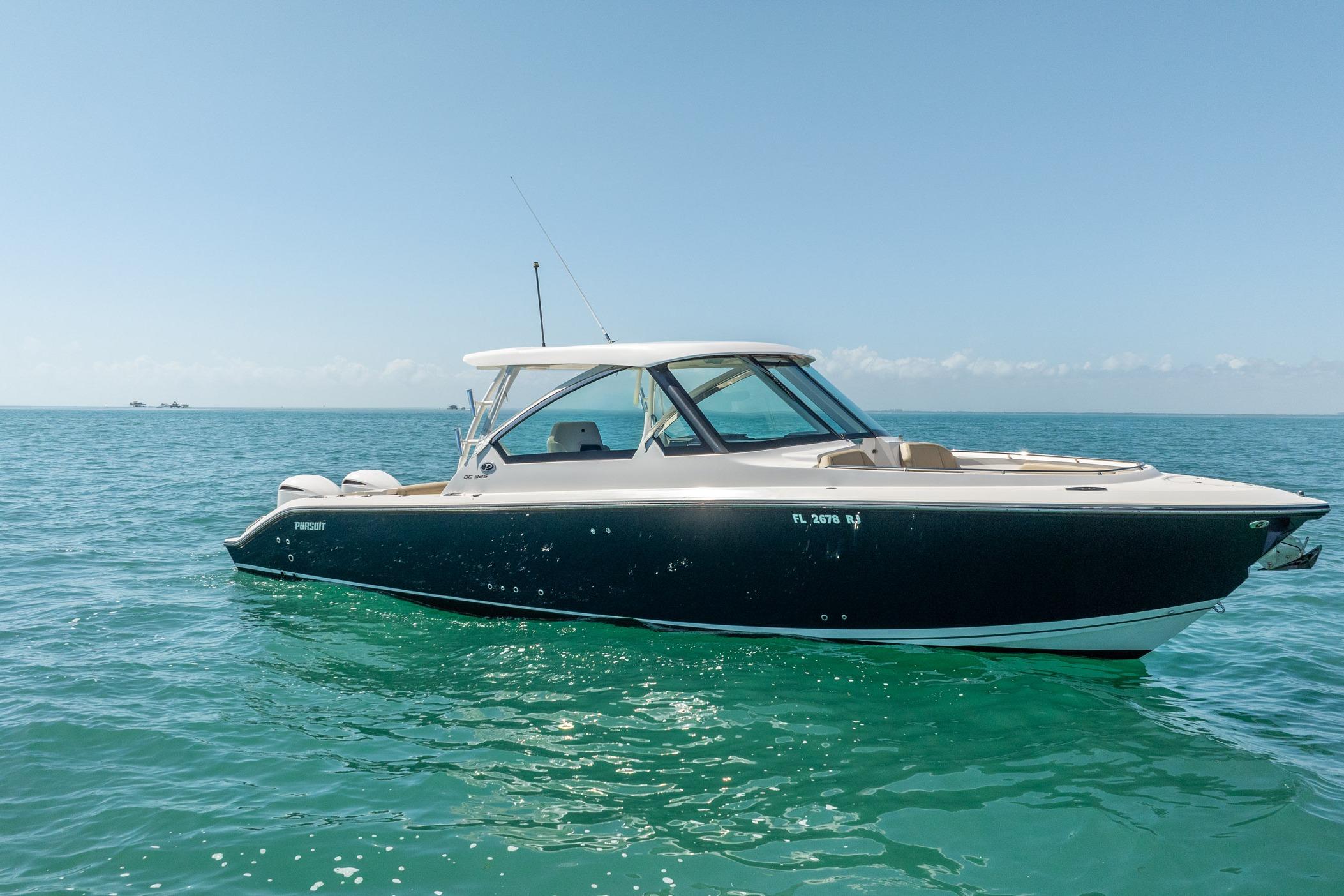 2017 Pursuit DC 325 Dual Console boat on calm ocean waters.