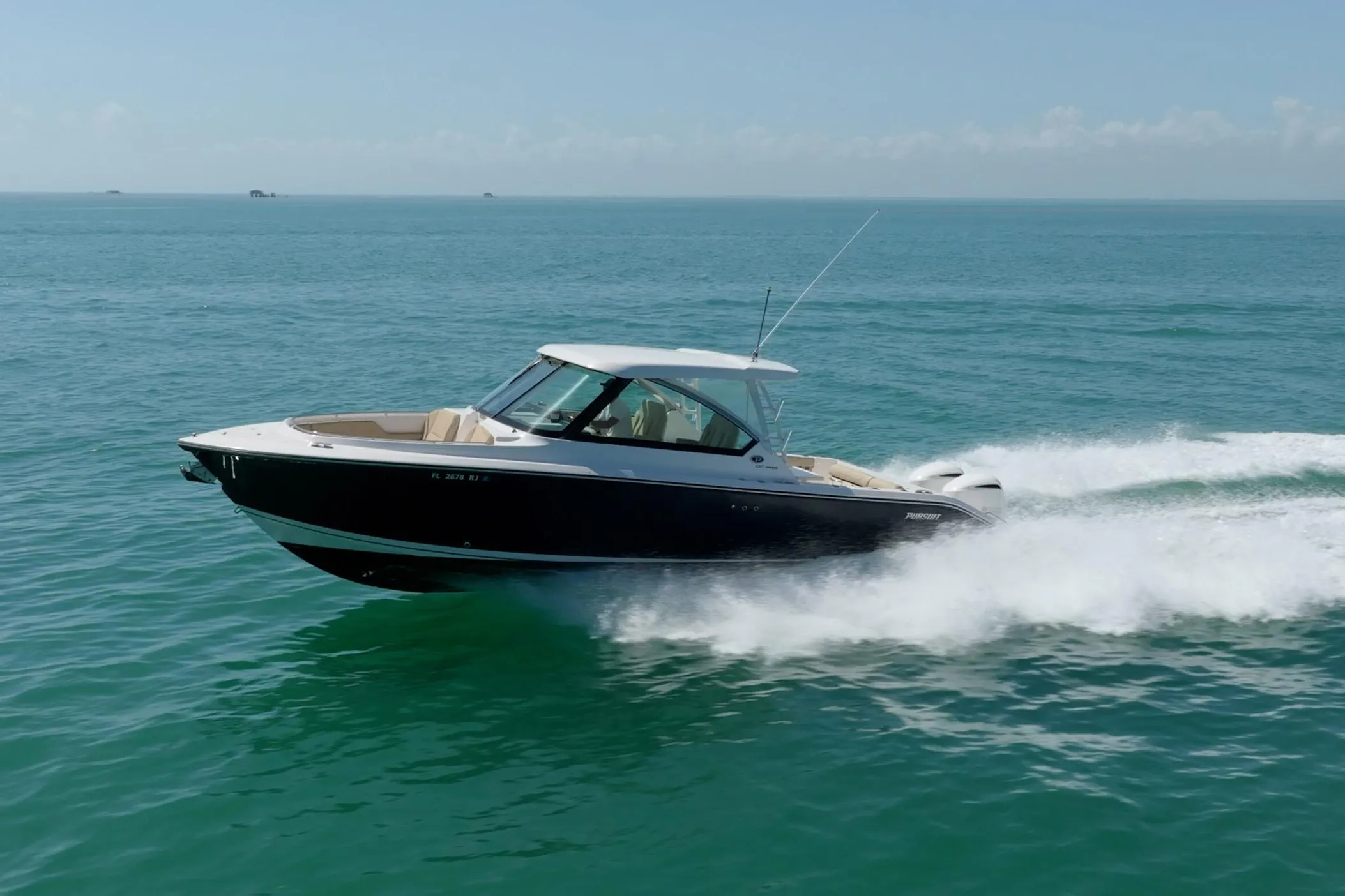2017 Pursuit DC 325 Dual Console boat cruising on open water.
