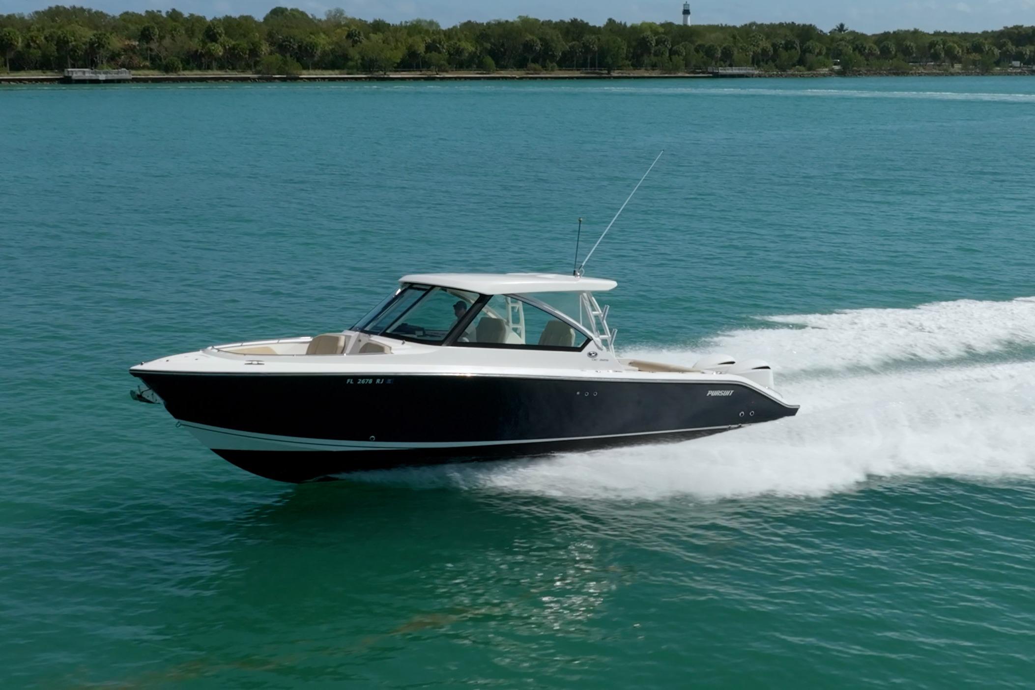 2017 Pursuit DC 325 Dual Console boat cruising on clear blue water.