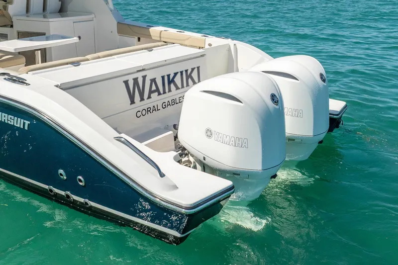 Waikiki Yacht Photos Pics 2017 Pursuit DC 325 Dual Console boat with twin Yamaha engines on turquoise water.