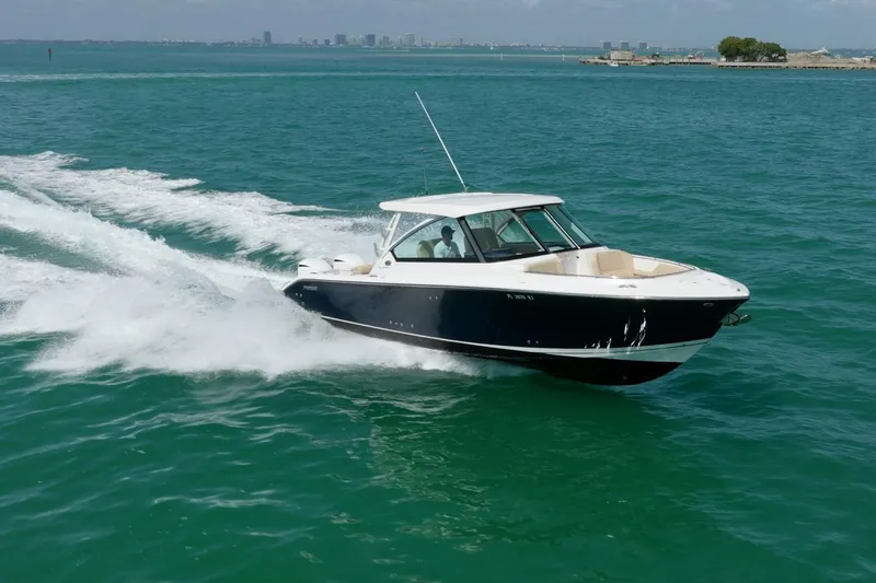 Waikiki Yacht Photos Pics 2017 Pursuit DC 325 Dual Console boat cruising on open water.