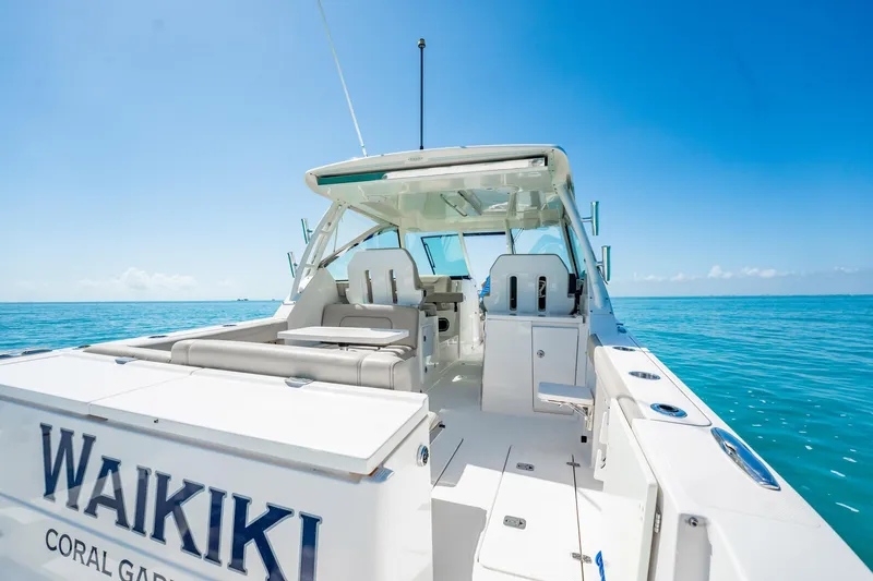 Waikiki Yacht Photos Pics 2017 Pursuit DC 325 Dual Console boat on clear blue ocean.