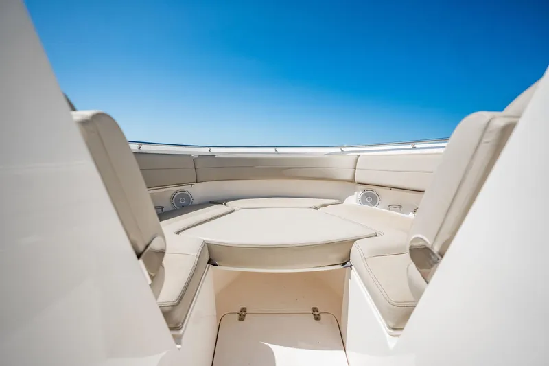 Waikiki Yacht Photos Pics 2017 Pursuit DC 325 Dual Console boat interior with beige seating under clear blue sky.