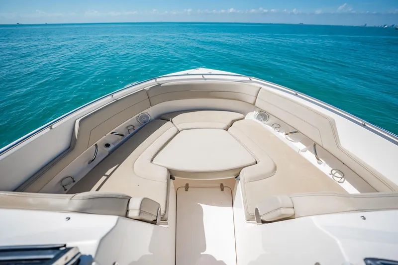 Waikiki Yacht Photos Pics 2017 Pursuit DC 325 Dual Console boat interior with beige seating on blue ocean.