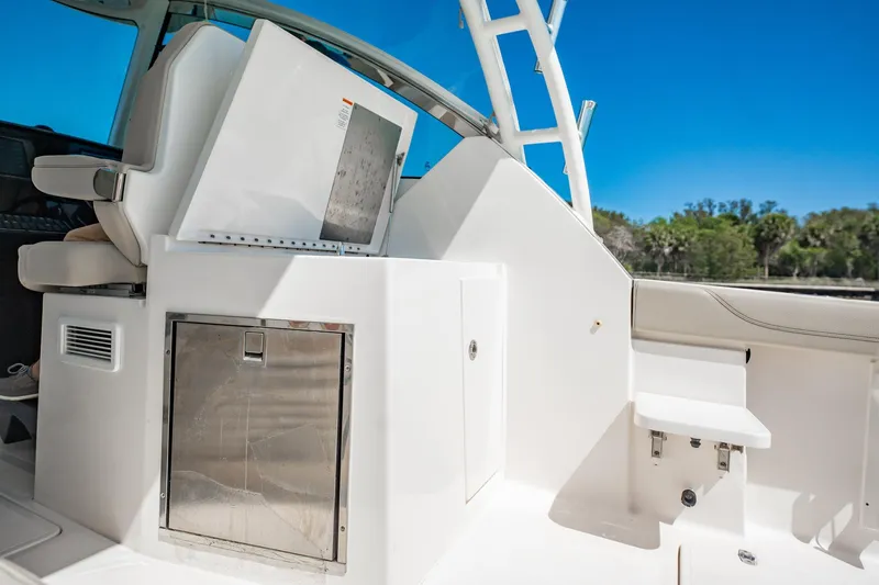 Waikiki Yacht Photos Pics 2017 Pursuit DC 325 Dual Console boat interior with seating and storage, under clear blue sky.