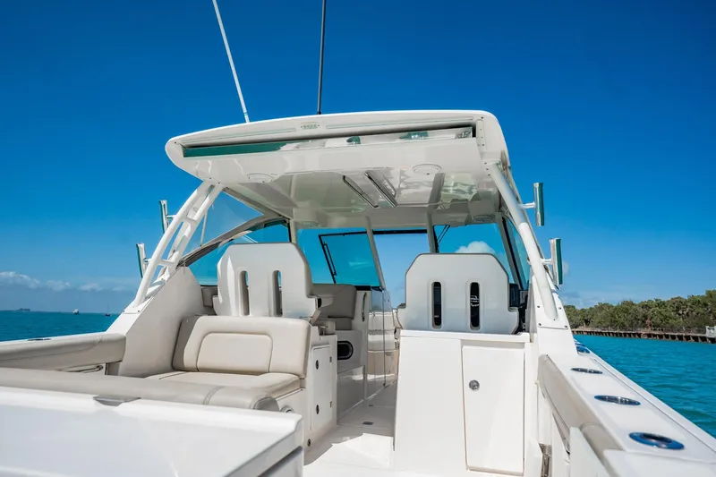 Waikiki Yacht Photos Pics 2017 Pursuit DC 325 Dual Console boat interior with seating, under clear blue sky.