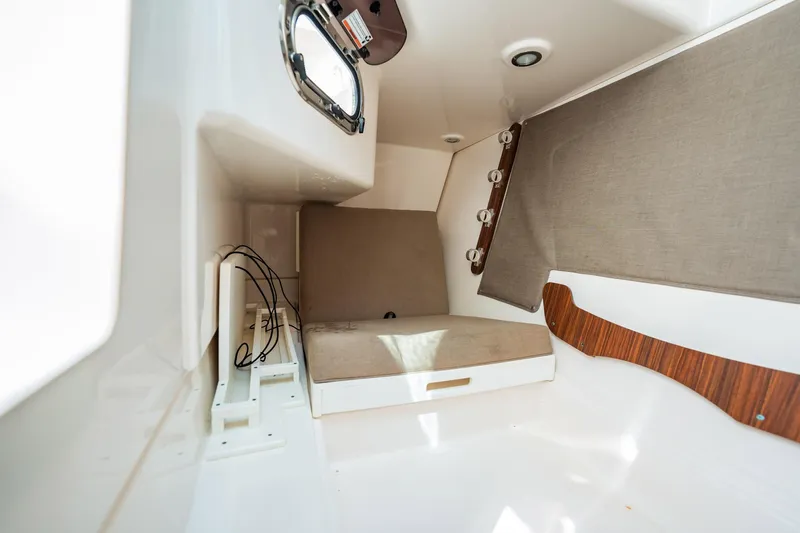 Waikiki Yacht Photos Pics 2017 Pursuit DC 325 Dual Console cabin interior with seating and storage.