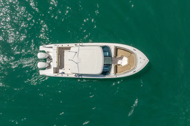 Waikiki Yacht Photos Pics Overhead view of 2017 Pursuit DC 325 Dual Console boat on turquoise water.