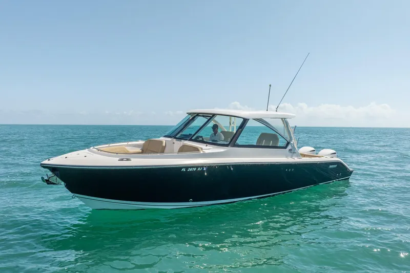 Waikiki Yacht Photos Pics 2017 Pursuit DC 325 Dual Console boat on clear blue ocean water.