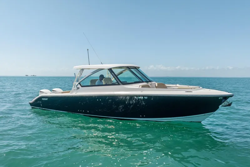 Waikiki Yacht Photos Pics 2017 Pursuit DC 325 Dual Console boat on clear blue water.