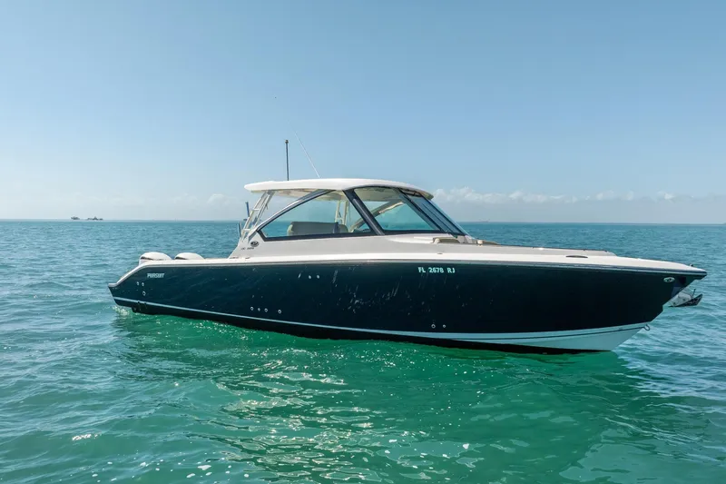 Waikiki Yacht Photos Pics 2017 Pursuit DC 325 Dual Console boat on clear blue ocean water.