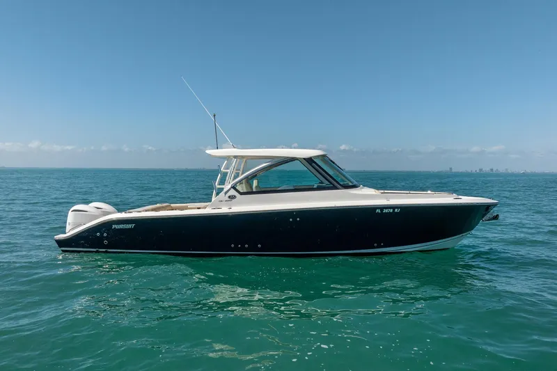 Waikiki Yacht Photos Pics 2017 Pursuit DC 325 Dual Console boat on calm ocean waters under clear blue sky.