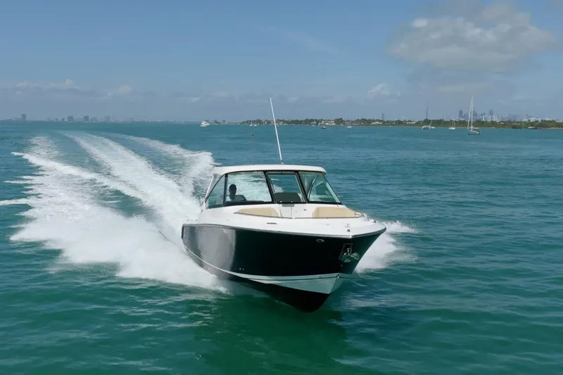 Waikiki Yacht Photos Pics 2017 Pursuit DC 325 Dual Console boat cruising on open water.