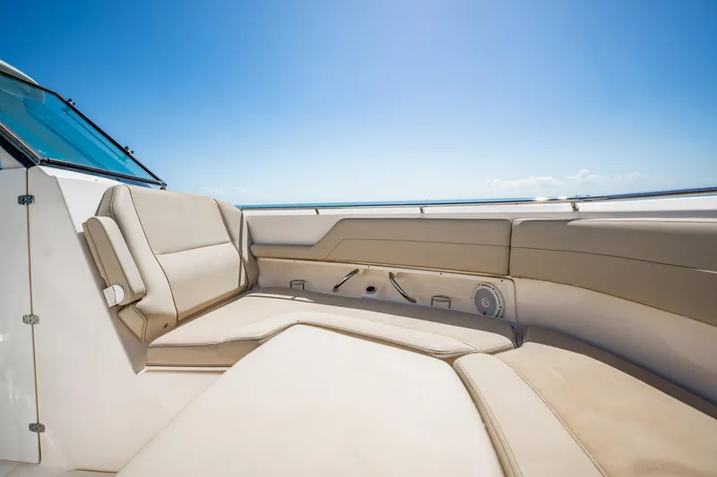 Waikiki Yacht Photos Pics Luxurious seating on 2017 Pursuit DC 325 Dual Console boat under clear blue sky.