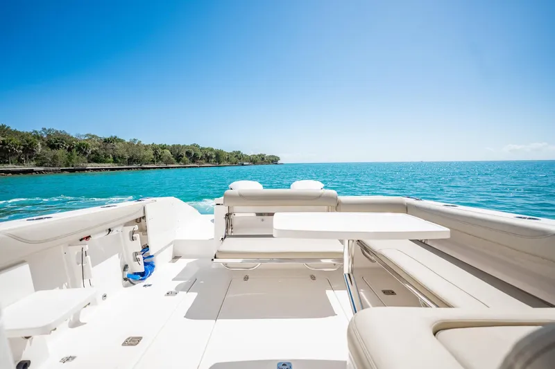 Waikiki Yacht Photos Pics 2017 Pursuit DC 325 Dual Console boat on clear blue water, sunny day.