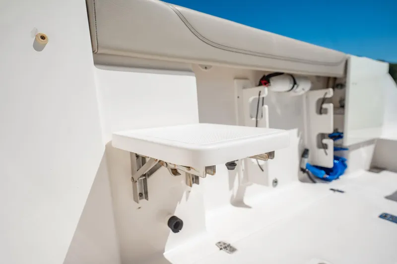 Waikiki Yacht Photos Pics 2017 Pursuit DC 325 Dual Console boat interior with foldable seat and storage features.