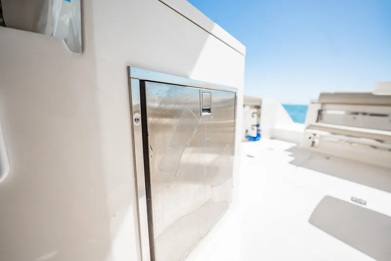 Waikiki Yacht Photos Pics 2017 Pursuit DC 325 Dual Console boat interior with stainless steel storage compartment.