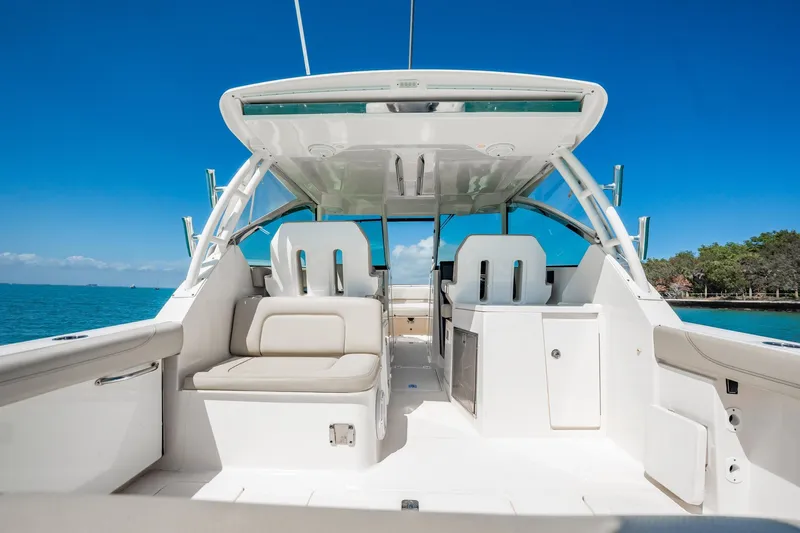 Waikiki Yacht Photos Pics 2017 Pursuit DC 325 Dual Console boat interior with seating, ocean view, and clear blue sky.