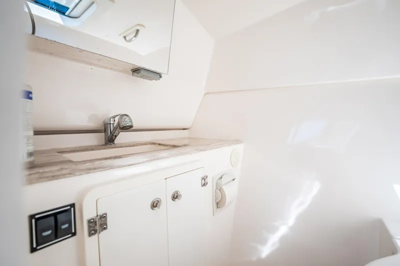 Waikiki Yacht Photos Pics 2017 Pursuit DC 325 Dual Console boat interior with sink and storage cabinet.