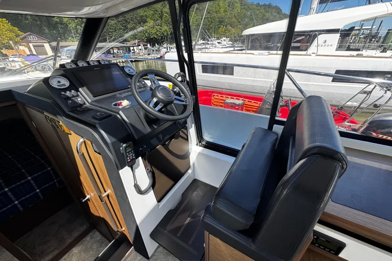  Yacht Photos Pics 2019 Jeanneau NC33 boat interior with steering wheel and control panel.