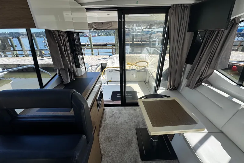  Yacht Photos Pics Interior of 2019 Jeanneau NC33 yacht with modern furnishings and marina view.
