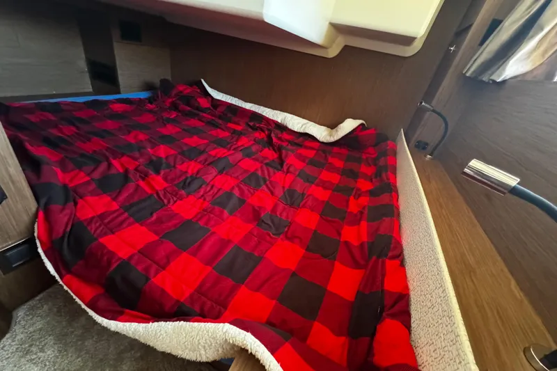  Yacht Photos Pics Cozy cabin bed with red plaid blanket in 2019 Jeanneau NC33 boat.