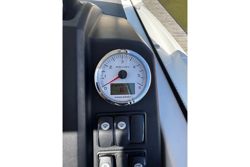  Yacht Photos Pics Close-up of Jeanneau NC33 2019 boat dashboard with RPM gauge and controls.