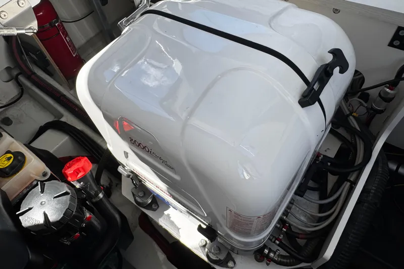  Yacht Photos Pics Engine compartment of a 2019 Jeanneau NC33 boat, featuring a generator and wiring.