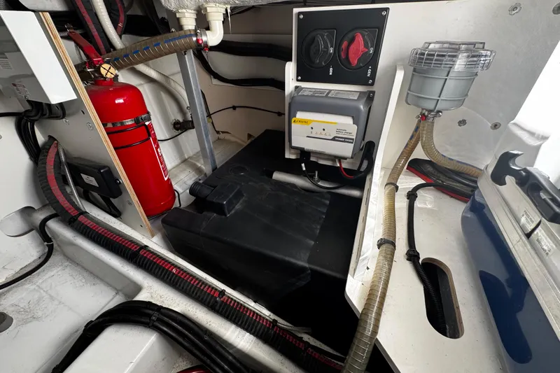  Yacht Photos Pics Engine room of 2019 Jeanneau NC33 boat with fire extinguisher and control panel.