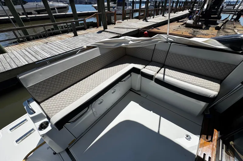  Yacht Photos Pics 2019 Jeanneau NC33 boat interior with quilted seating at a marina.