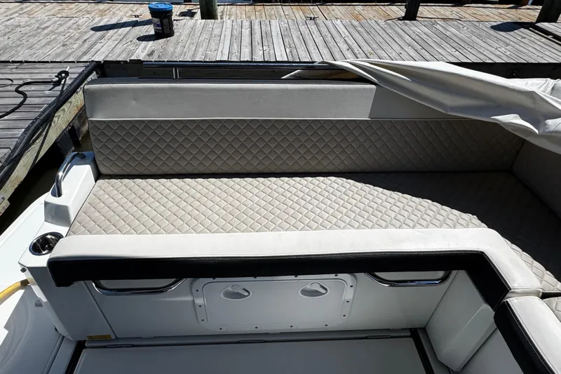  Yacht Photos Pics Quilted seating on 2019 Jeanneau NC33 boat, docked with cover partially removed.