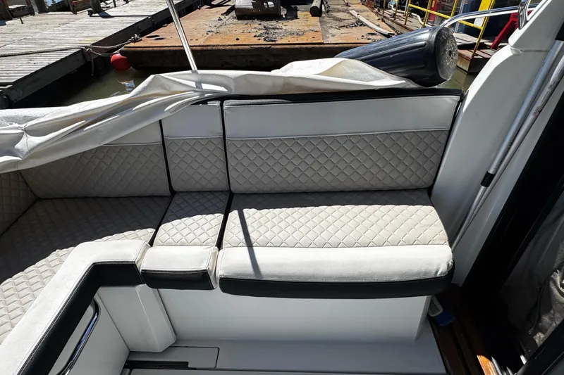  Yacht Photos Pics Luxurious seating on a 2019 Jeanneau NC33 boat, featuring quilted upholstery.