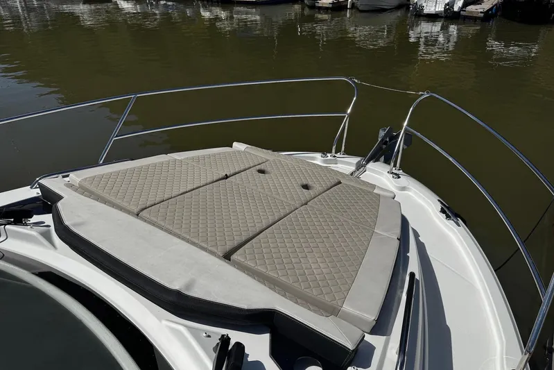  Yacht Photos Pics Bow sunpad on 2019 Jeanneau NC33 yacht, docked on calm water.